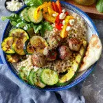Greek meatball bowl Recipe 15 Greek meatball bowl with couscous, grilled vegetables, fresh spinach, feta, and pita bread