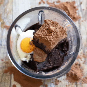 Eggs, cottage cheese, cocoa powder, and chocolate in food processor