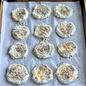 Unbaked cottage cheese chip rounds on a baking tray