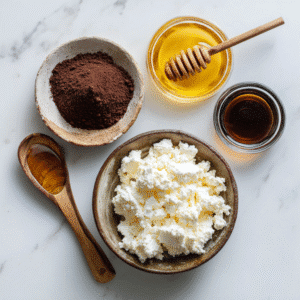 Ingredients for chocolate mousse including cocoa, honey, vanilla, and cottage cheese