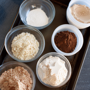 Protein brownie ingredients including protein powder, cocoa, almond flour, and yogurt