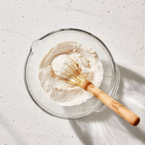 Whisking dry ingredients in bowl for fluffy flapjacks