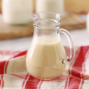 Glass jug filled with golden homemade condensed milk recipe